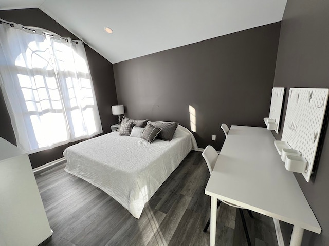 bedroom with lofted ceiling, multiple windows, baseboards, and dark wood-type flooring