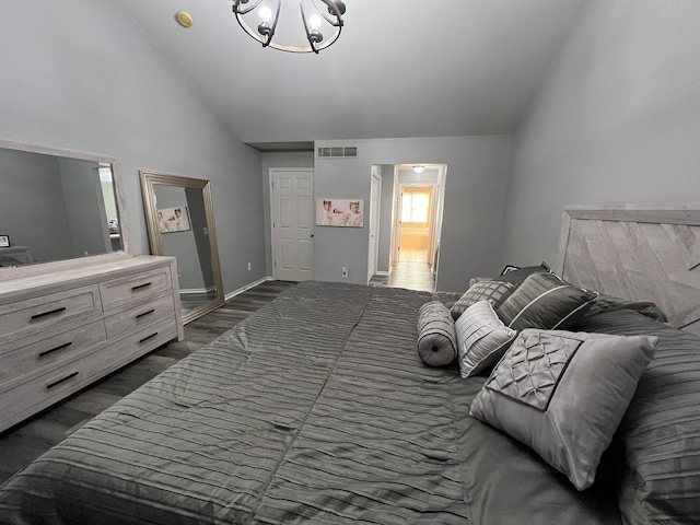 bedroom featuring dark wood-type flooring, lofted ceiling, and visible vents