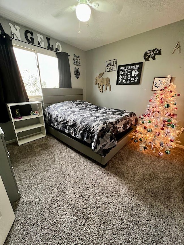 bedroom with a textured ceiling and a ceiling fan