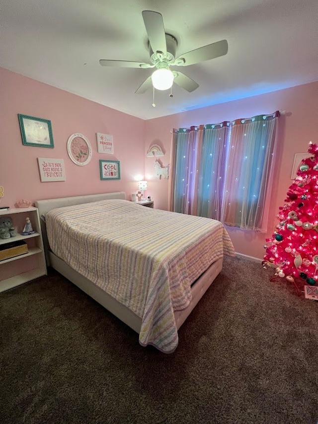 bedroom with dark colored carpet and a ceiling fan