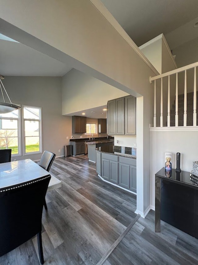 119 Prestwick Trl, Highland, MI 48357 - dining area featuring dark wood-style floors, crown molding, baseboards, and high vaulted ceiling