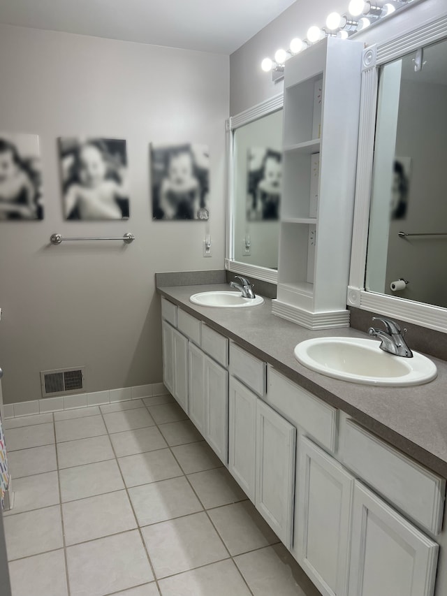 bathroom with double vanity, tile patterned flooring, a sink, and visible vents