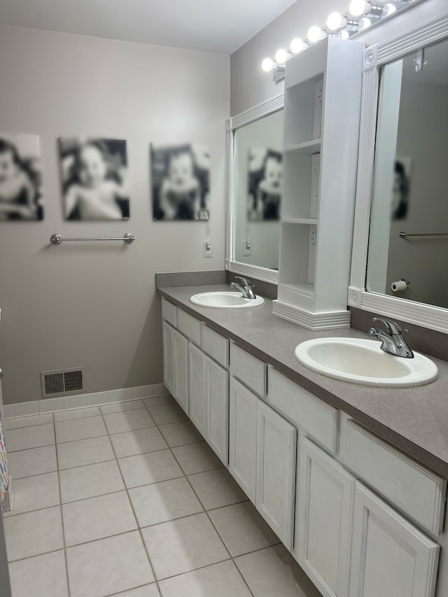119 Prestwick Trl, Highland, MI 48357 - full bath featuring double vanity, visible vents, tile patterned flooring, and a sink