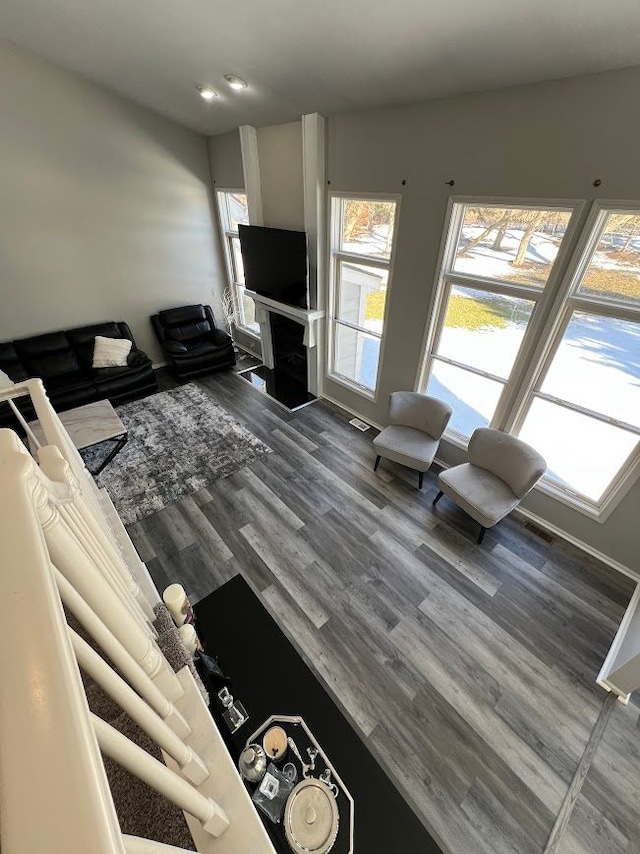 unfurnished living room with dark wood finished floors and a wealth of natural light