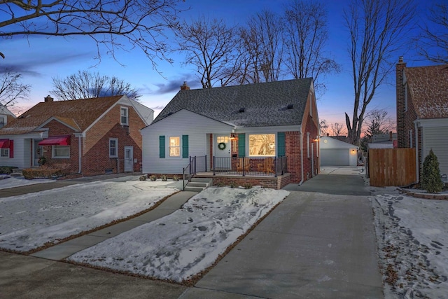 bungalow-style house with a garage and an outbuilding