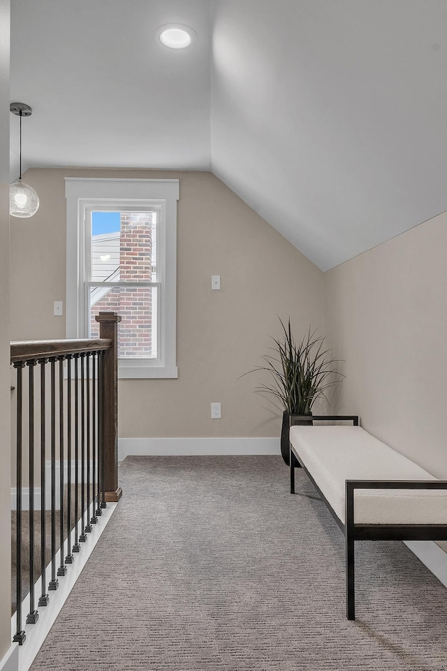 living area with vaulted ceiling and carpet