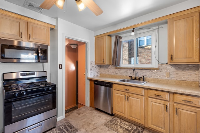 kitchen with tasteful backsplash, sink, stainless steel appliances, and ceiling fan