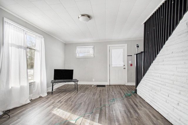 unfurnished room with plenty of natural light, crown molding, and wood-type flooring