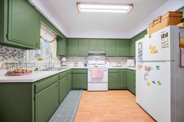 kitchen with green cabinets, sink, light hardwood / wood-style flooring, and white appliances