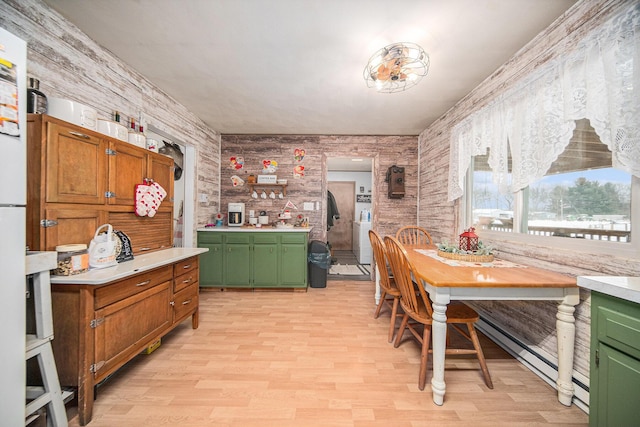 kitchen with baseboard heating and light wood-type flooring