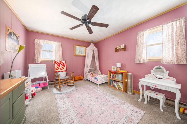 game room featuring ceiling fan, light colored carpet, and crown molding