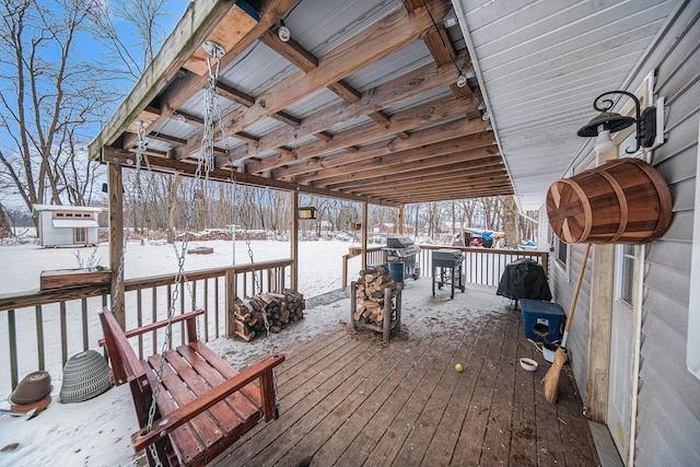 snow covered deck with an outbuilding