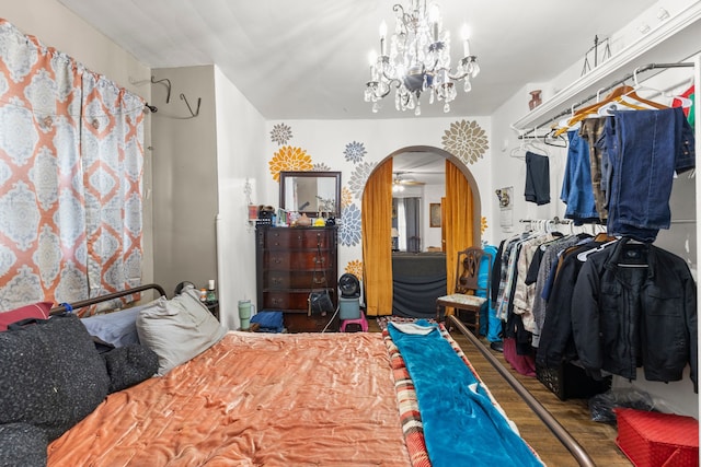 bedroom with wood-type flooring and a chandelier