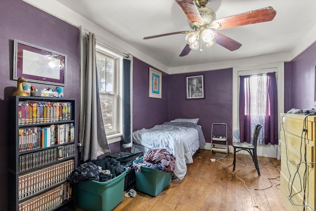 bedroom with ceiling fan and wood-type flooring