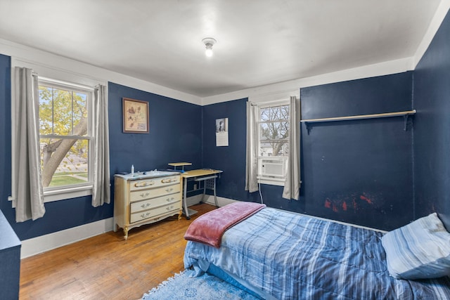 bedroom with cooling unit and hardwood / wood-style floors