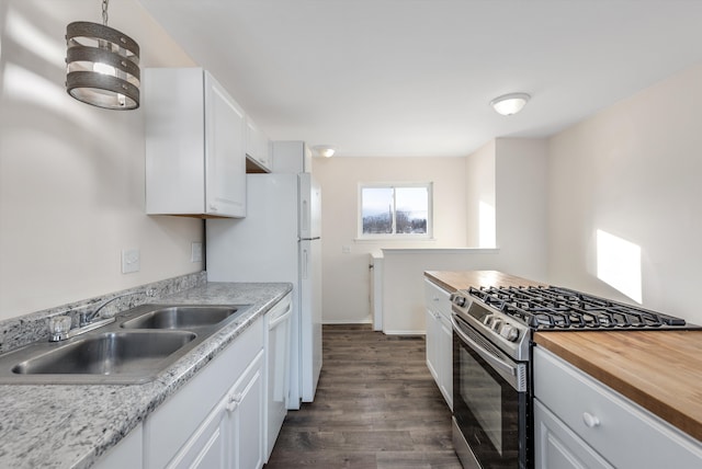 kitchen featuring sink, white cabinets, stainless steel range with gas cooktop, dark wood-type flooring, and butcher block counters