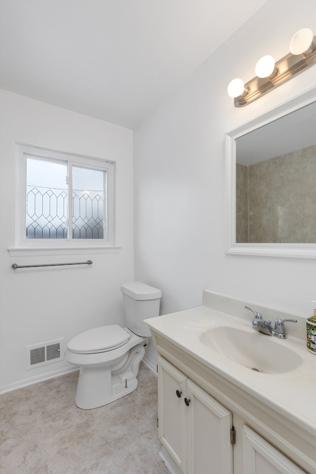 bathroom with toilet and vanity