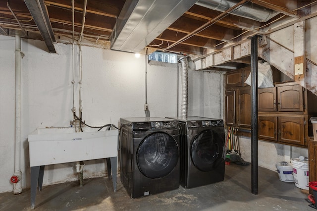 basement featuring sink and washer and dryer