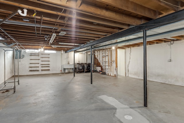 basement with sink and washer and dryer