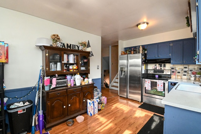 kitchen featuring sink, light wood-type flooring, and appliances with stainless steel finishes