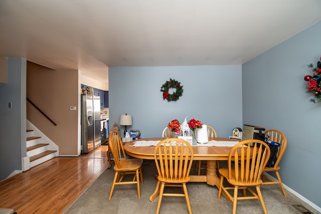 dining space with hardwood / wood-style flooring