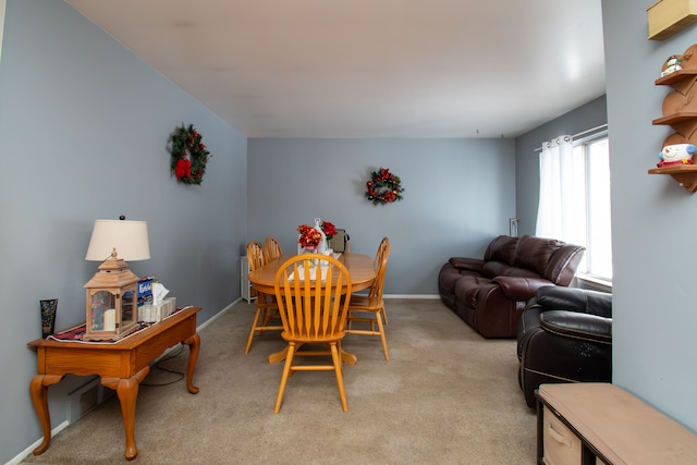 dining space featuring light colored carpet