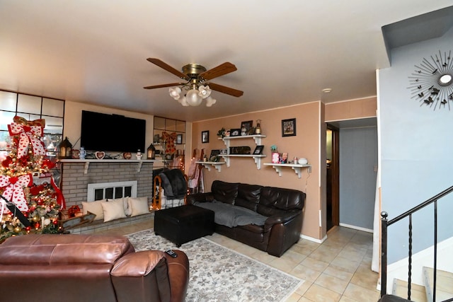 tiled living room with ceiling fan and a brick fireplace