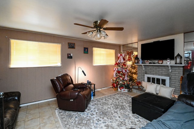 living room with a fireplace, light tile patterned floors, and ceiling fan