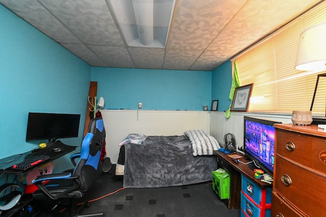 carpeted bedroom featuring a paneled ceiling