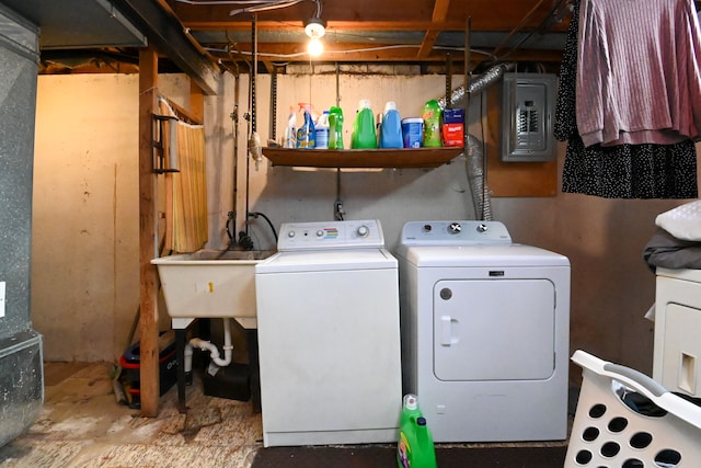 clothes washing area with electric panel and washer and dryer