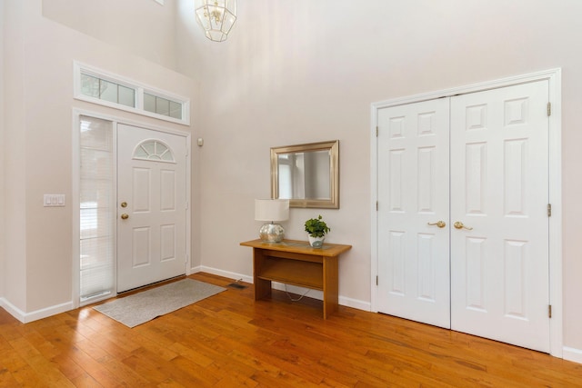 foyer featuring light hardwood / wood-style floors and a high ceiling