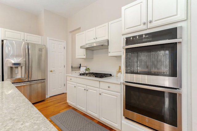 kitchen featuring white cabinetry, appliances with stainless steel finishes, and light wood-type flooring