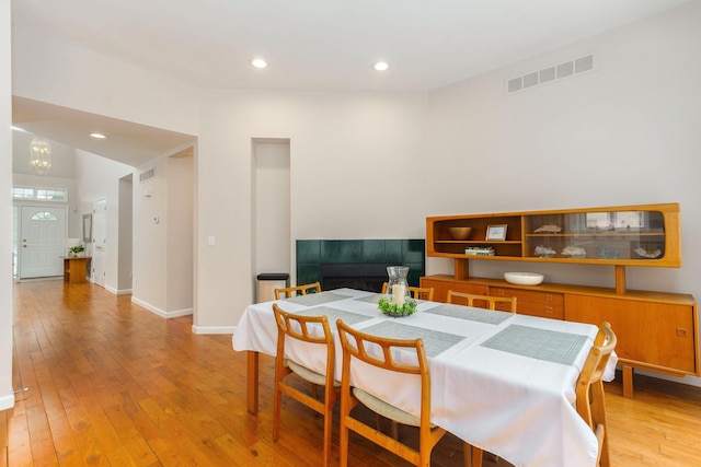 dining space featuring a chandelier and light wood-type flooring