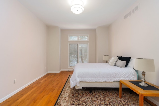 bedroom with hardwood / wood-style flooring