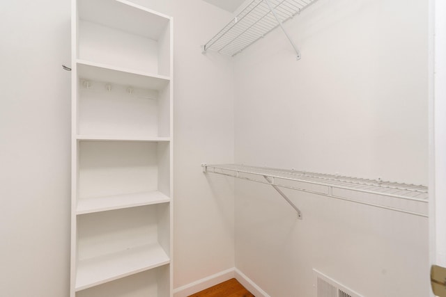 spacious closet featuring hardwood / wood-style floors