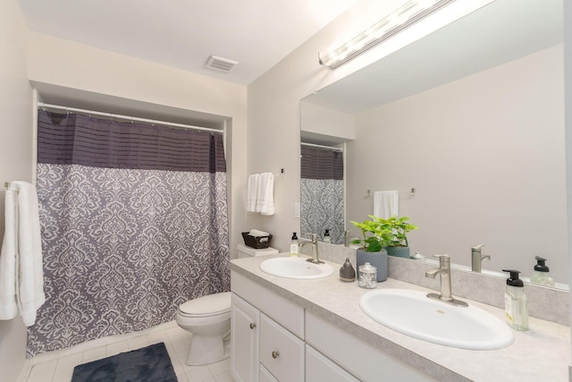 bathroom with tile patterned floors, vanity, and toilet