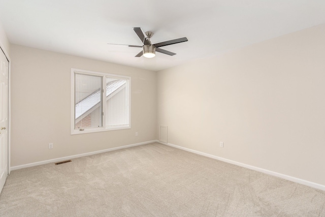 unfurnished room featuring ceiling fan and light colored carpet