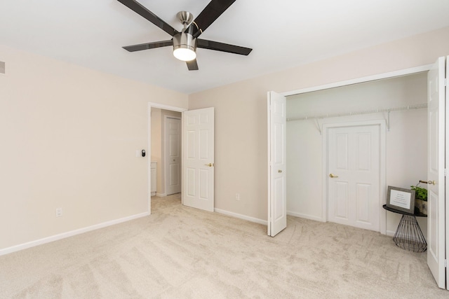 unfurnished bedroom featuring a closet, ceiling fan, and light colored carpet