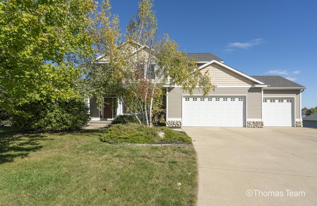 view of front of property with a garage and a front lawn