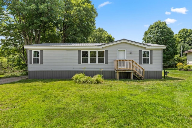 rear view of property featuring a yard