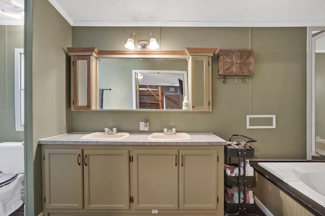 bathroom featuring vanity, ornamental molding, a textured ceiling, and toilet