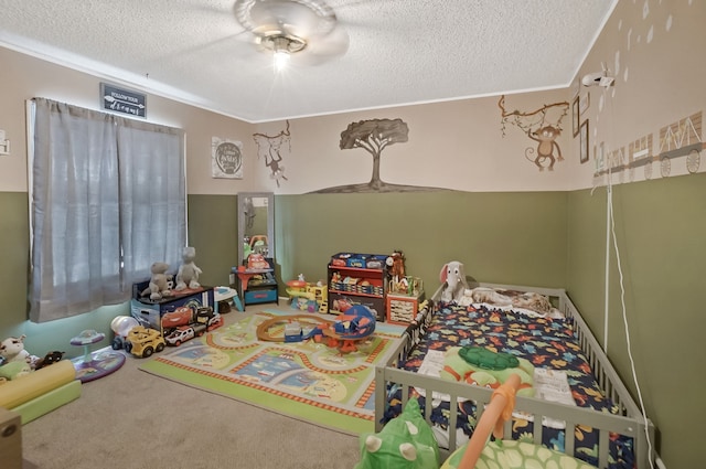 game room with a textured ceiling and carpet