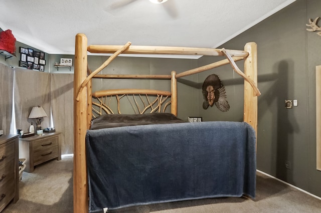 bedroom featuring ornamental molding, a textured ceiling, and carpet flooring