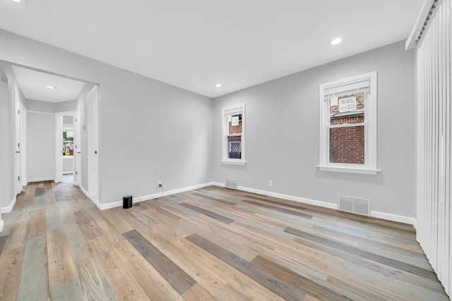 unfurnished room with light wood-type flooring