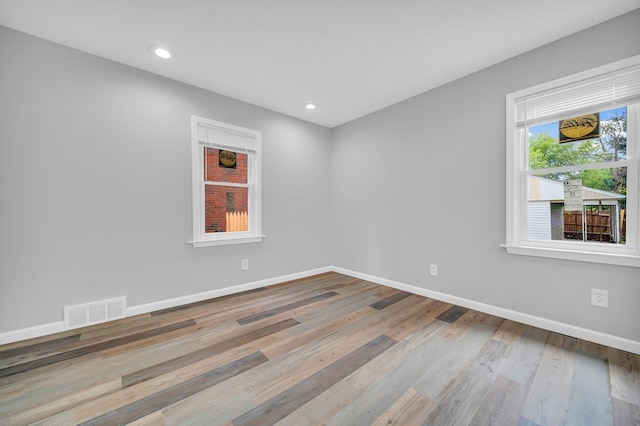 spare room with light hardwood / wood-style flooring