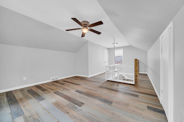 bonus room with ceiling fan, vaulted ceiling, and hardwood / wood-style flooring