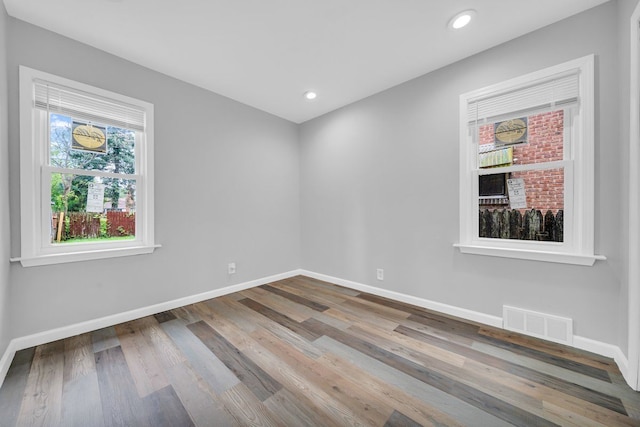 spare room with hardwood / wood-style floors