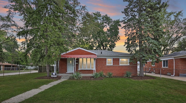 bungalow featuring a yard