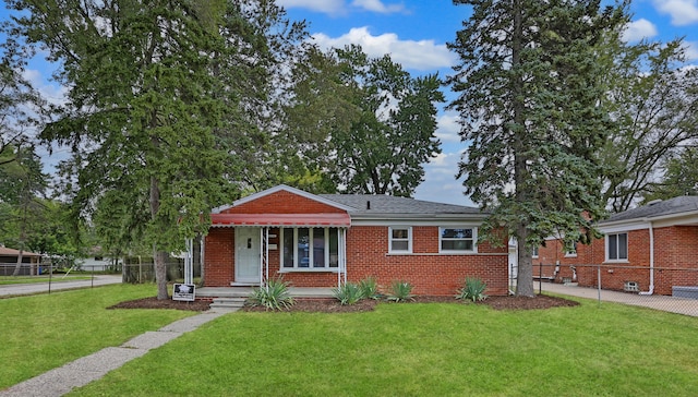 bungalow-style home featuring a front lawn