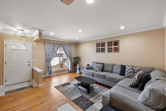 living room featuring ornamental molding and light hardwood / wood-style floors